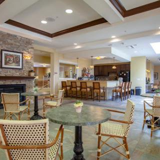 A cozy and inviting lounge area featuring a fireplace and a bar, perfect for social gatherings.