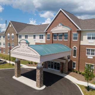 A modern commercial building with a covered entrance and attractive architectural design.
