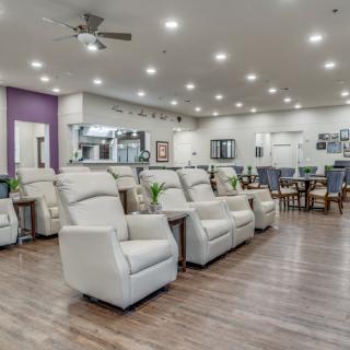 A modern waiting area featuring rows of comfortable recliners.