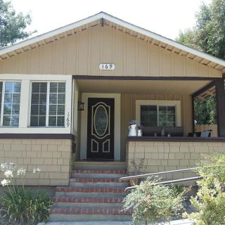 A suburban house with a front porch and garden.