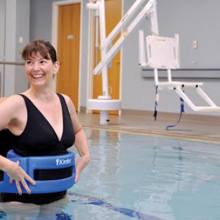 A woman enjoying her water therapy session in a swimming pool.