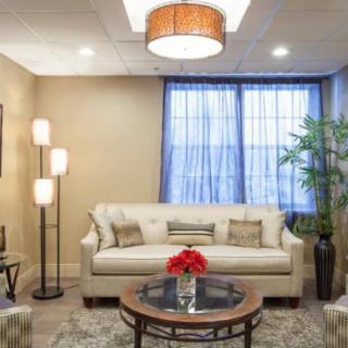 A modern living room with a comfortable sofa, elegant lighting, and tasteful decor.