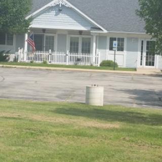 A peaceful residential setting with a house and a flag in the foreground.