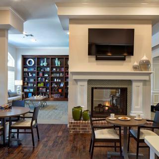 A cozy living room with a fireplace, television, and comfortable seating area.