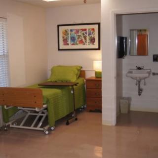 A hospital room featuring a bed and sink, designed for patient care.