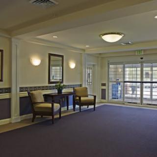 A spacious lobby with seating and large windows.