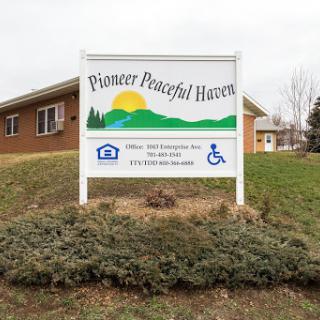 Sign for Pioneer Peaceful Haven, indicating a community space surrounded by nature.