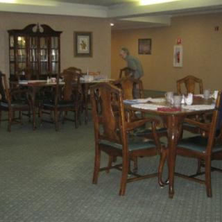 An empty dining area with neatly arranged tables and chairs.