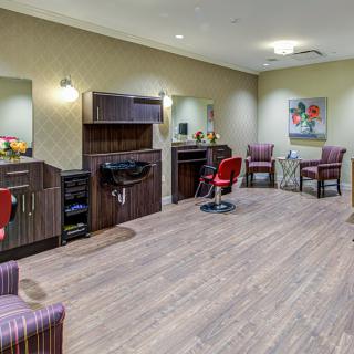 Modern hair salon interior with styling stations and comfortable chairs.