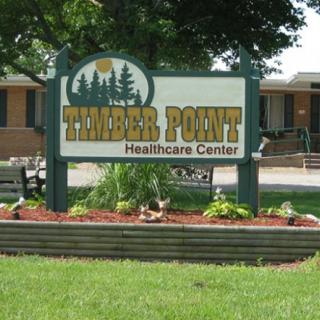 Sign for Timber Point Healthcare Center with landscaping.