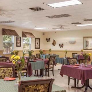 A cozy dining room with neatly set tables and warm decor.