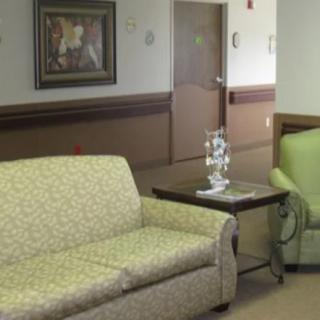 A quiet lobby area with patterned sofas and wall art.