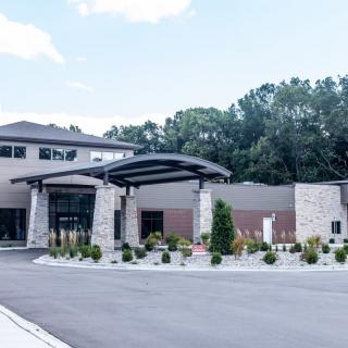 A modern building with a stylish entrance and landscaped surroundings.