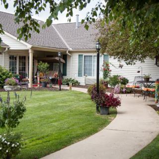 A charming house with a well-maintained garden and pathway.