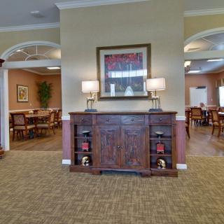 A cozy interior with a wooden cabinet and dining area in the background.