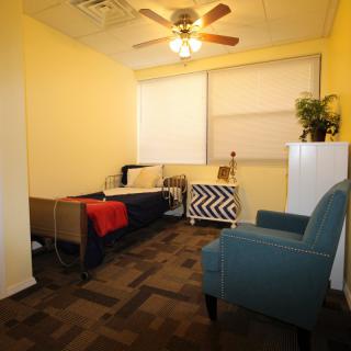 A cozy room featuring a sofa, armchair, and decorative elements.