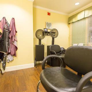 A tidy and well-equipped hair salon interior with styling chairs and professional tools.