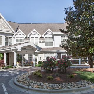 A well-maintained building with landscaped gardens and a welcoming entrance.