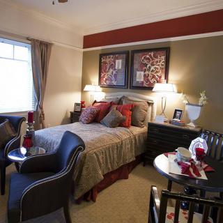 A cozy bedroom interior with a double bed, stylish decor, and warm lighting.