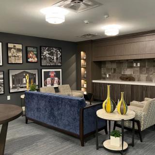 A modern living room featuring a cozy seating area, wall art, and decorative accents.