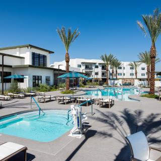 A luxurious resort featuring multiple swimming pools and surrounded by palm trees.