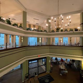 A beautifully designed multi-level lobby with elegant lighting and lush plants.