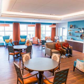 A welcoming living room with various seating arrangements and bright, colorful decor.