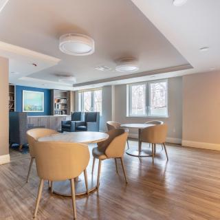 A modern dining area with wooden flooring and contemporary furniture.