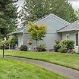 A suburban house with a well-maintained lawn and garden.