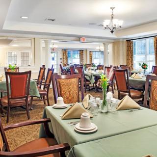 An elegant dining area with neatly arranged tables and chairs, ready for guests.