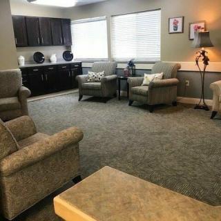 A cozy living room with comfortable armchairs and large windows.