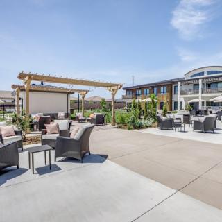 Modern outdoor patio area with comfortable seating and a pergola.