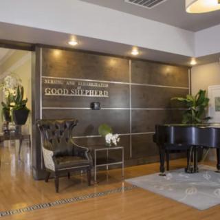 A luxurious reception area featuring a grand piano and elegant seating.