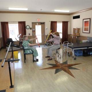 Two individuals engaged in a physical therapy session at a healthcare facility.