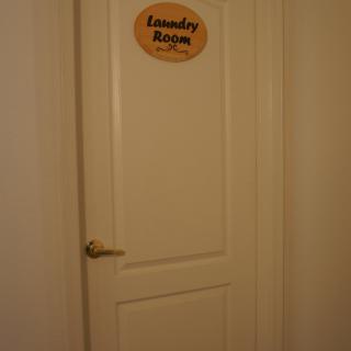 A closed door with a 'Laundry Room' sign.
