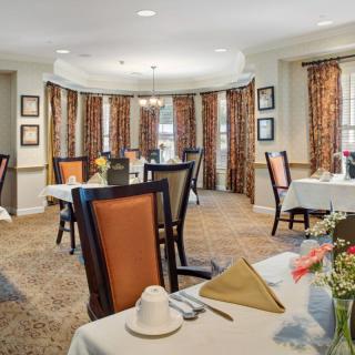 Elegant dining room with neatly arranged tables and chairs.