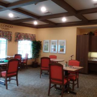 A cozy dining area with red chairs and well-lit spaces, perfect for gatherings.