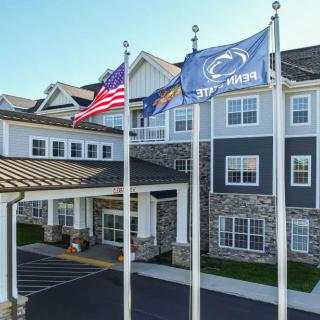 A hotel entrance with flags displayed outside.