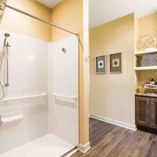 A modern bathroom with a walk-in shower and a stylish sink area.