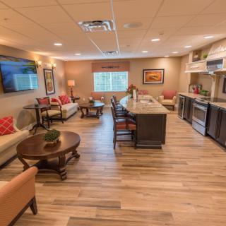 Modern open-plan living and kitchen area with hardwood floors.