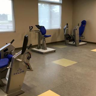 A quiet workout room with various exercise machines.