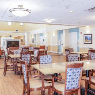 An empty dining area with neatly arranged tables and chairs.