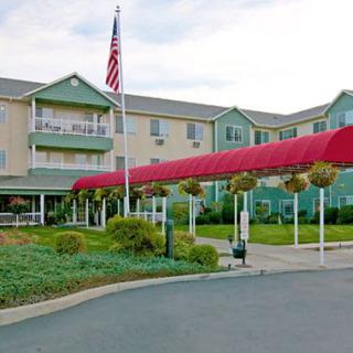A hotel building with a red canopy entrance and an American flag.