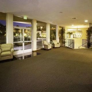 A spacious lobby with comfortable seating and large windows.