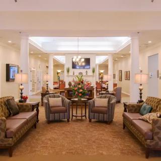 A cozy and elegantly decorated living room featuring plush sofas, warm lighting, and classic decor.