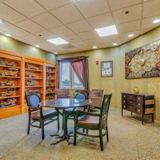 Cozy library room with bookshelves and a seating area.