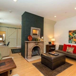 A cozy and modern living room with a central fireplace and stylish decor.