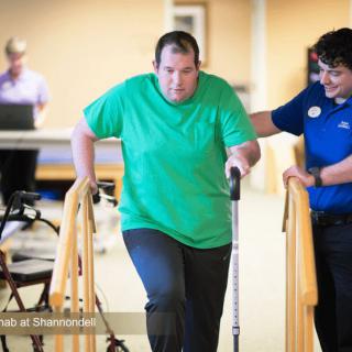 A person receives support during a physical therapy session.