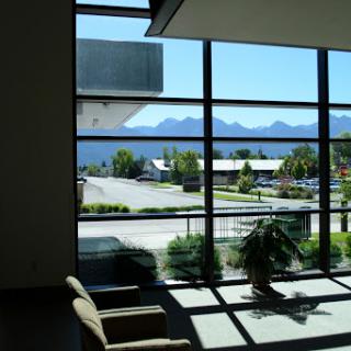A bright lobby with large windows showcasing a scenic view of the mountains outside.