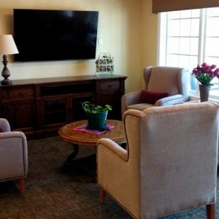 A cozy living room with comfortable seating and a large television.